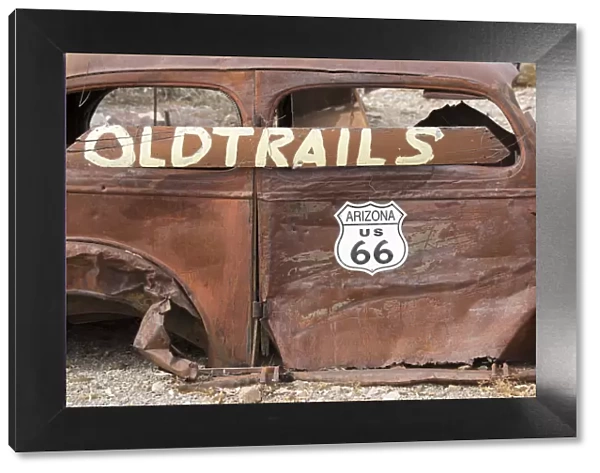 USA, Arizona, Oatman, Route 66, old car rusting away by the side of the road