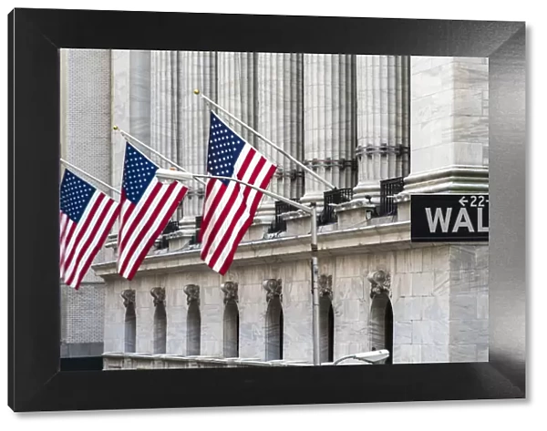 Wall Street sign with New York Stock Exchange behind, Lower Manhattan, New York, USA
