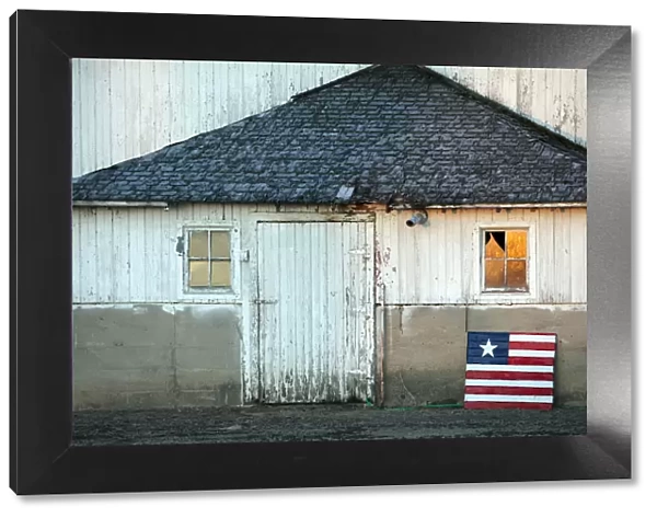 Idaho, USA. An american flag in front of a barn