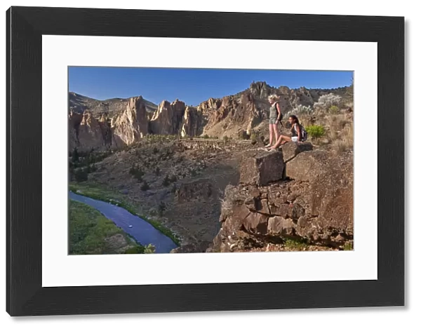 Two girls resting on cliff face, Smith Rock State Park, Central Oregon, USA MR