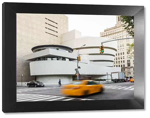 Taxis passing the Solomon R Guggenheim Museum, New York, USA