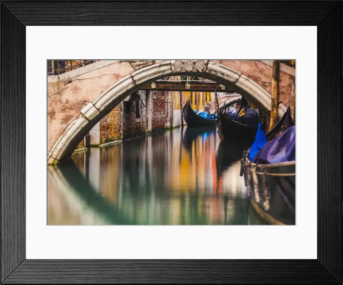 Framed Print : Venice, Veneto, Italy. Moored gondolas under stone bridges
