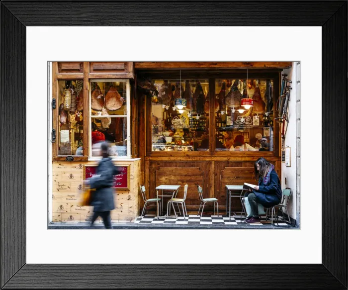 Framed Print : Girl reading in front of a traditional Salumeria in Bologna, Emilia Romagna, Italy Framed Print : Girl reading in front of a traditional Salumeria in Bologna, Emilia Romagna, Italy