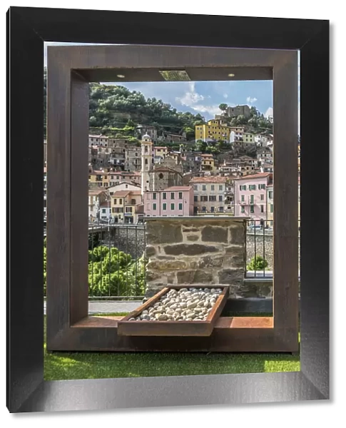 Europe, Italy, Liguria. Badalucco. A view of the town through a frame