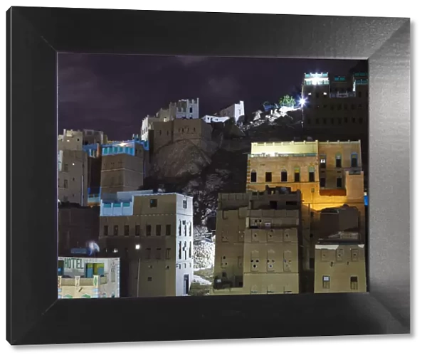 Yemen, Hadhramaut, Wadi Do an, Khuraibah. Buildings lit at night