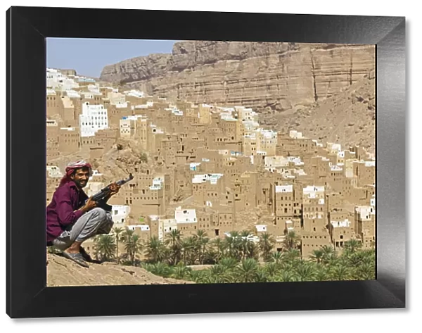 Yemen, Hadhramaut, Wadi Do an, Ribat Ba-Ashan. A happy Yemeni man holds his AK-47