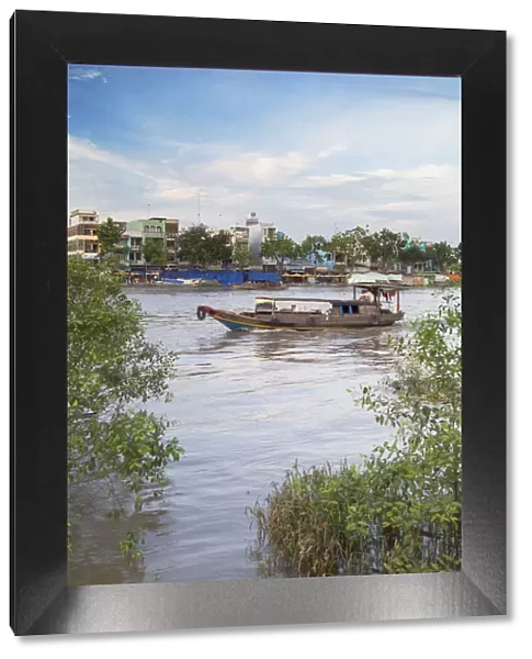 Boat passing along Ben Tre River, Ben Tre, Mekong Delta, Vietnam