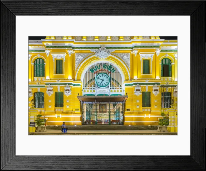 Framed Print : A security guard sits outside of Saigon Central Post Office at night, Ho Chi Minh City