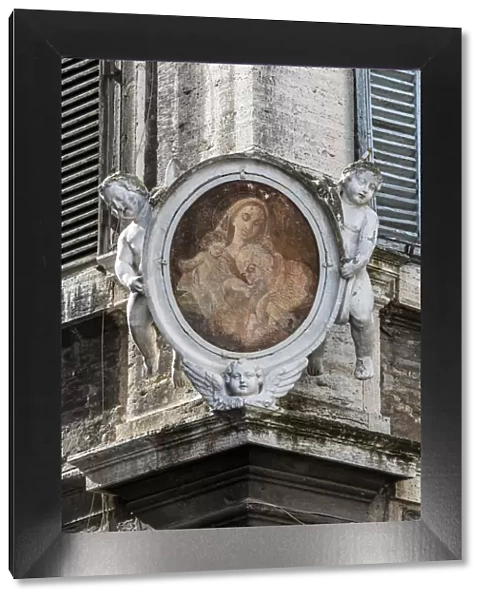 Traditional Madonnella or Madonna painting placed in a buildings corner, Rome, Lazio