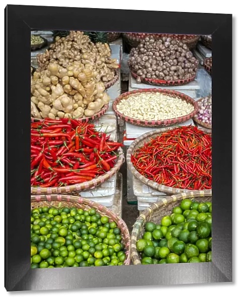 Chili peppers, limes, ginger and garlic for sale at Đồng Xuan