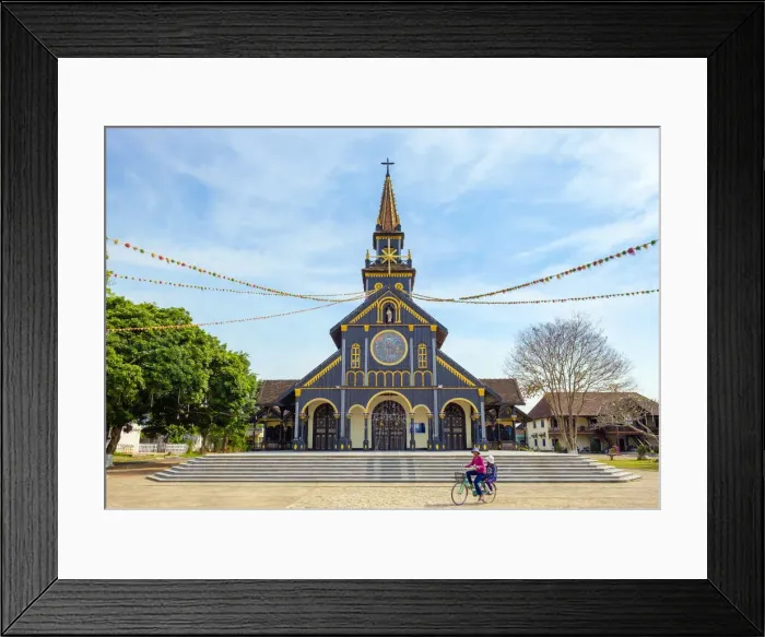 Framed Print : Childen ride a biycycle in front of Kon Tum Cathedral, also known as Wooden Church Framed Print : Childen ride a biycycle in front of Kon Tum Cathedral, also known as Wooden Church