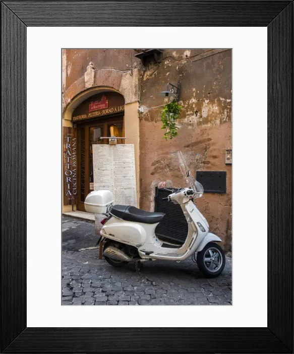 Framed Print : Italian Vespa scooter parked outside a trattoria restaurant in a cobblestone street
