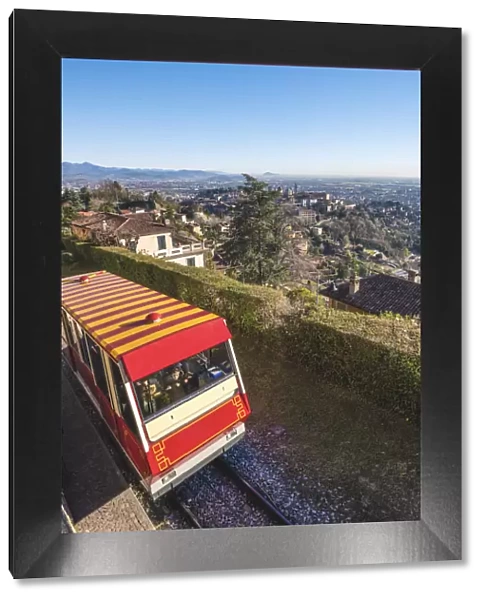 Bergamo, Lombardy, Italy. Cable car with Upper Town (Citta Alta) in the background