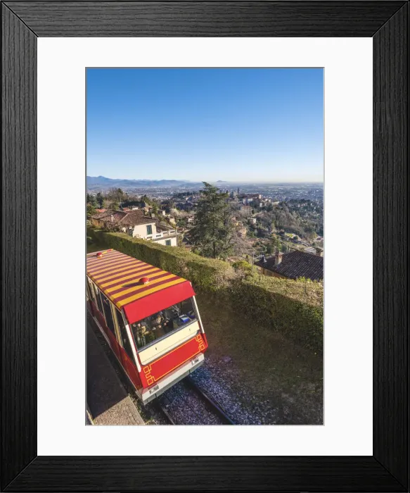 Framed Print : Bergamo, Lombardy, Italy. Cable car with Upper Town (Citta Alta) in the background
