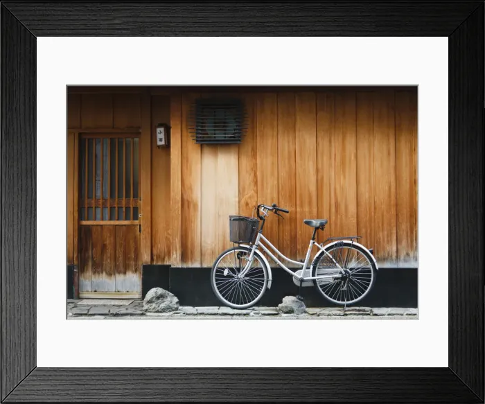 Framed Print : Japan, Chubu Region, Kyoto, Gion. A bicycle rests against the wall of a traditional Framed Print : Japan, Chubu Region, Kyoto, Gion. A bicycle rests against the wall of a traditional