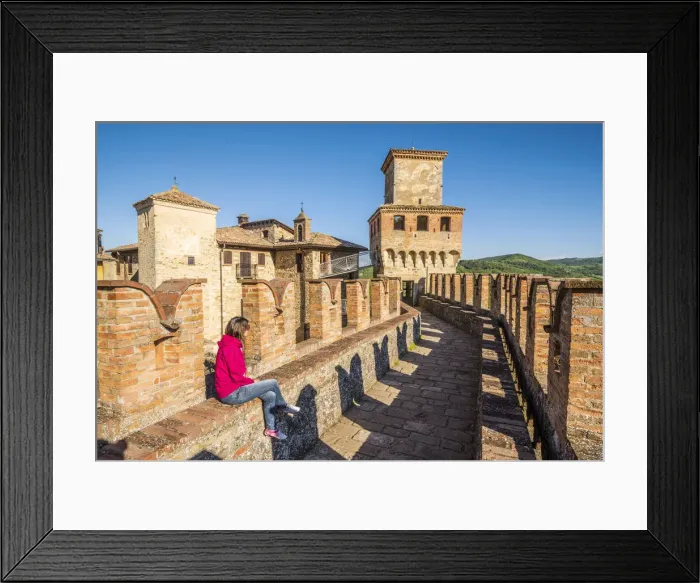 Framed Print : Vigoleno, Piacenza, Emiglia-Romagna, Italy. Woman sitting on the castle walls Framed Print : Vigoleno, Piacenza, Emiglia-Romagna, Italy. Woman sitting on the castle walls