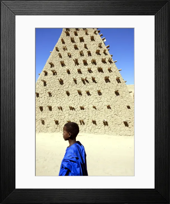 Framed Print : Boy walking along the Sankore mosque, a UNESCO World Heritage Site. Timbuktu, Mali Framed Print : Boy walking along the Sankore mosque, a UNESCO World Heritage Site. Timbuktu, Mali