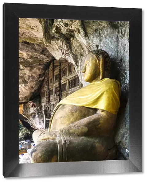 Laos, Luang Prabang. Buddha statue at the entrance of Pak Ou Caves on the Mekong river
