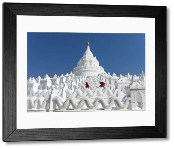 Framed Print : Two young Buddhist monks run and jump across the white walls of Hsinbyume Pagoda, Mingun Framed Print : Two young Buddhist monks run and jump across the white walls of Hsinbyume Pagoda, Mingun