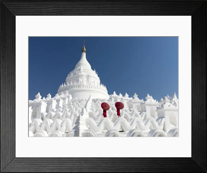 Framed Print : Two young Buddhist monks stand on the white walls of Hsinbyume Pagoda holding red Framed Print : Two young Buddhist monks stand on the white walls of Hsinbyume Pagoda holding red