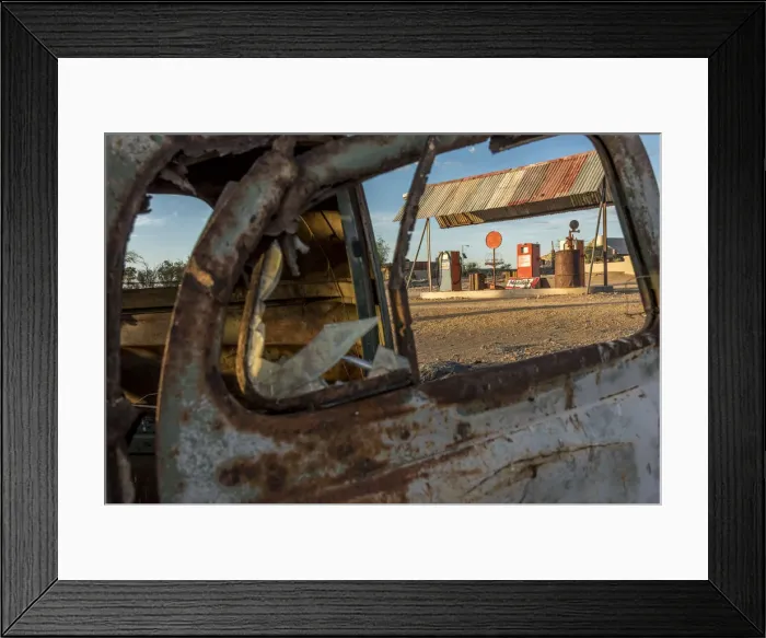 Framed Print : Africa, Namibia, Keetmanshop. Old petrol station seen through a rusty car door Framed Print : Africa, Namibia, Keetmanshop. Old petrol station seen through a rusty car door