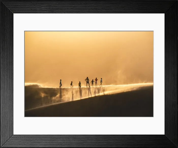 Framed Print : Walvis Bay, Namibia, Africa. People walking on the edge of a sand dune at sunset