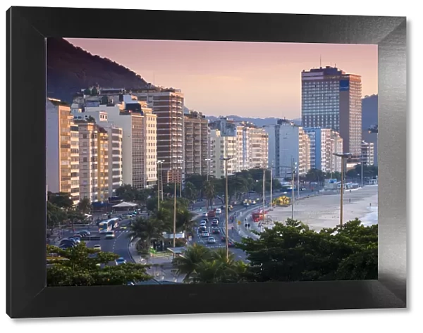 Brazil, Rio De Janeiro, Copacabana, Traffic along Avenue Atlantica at dawn