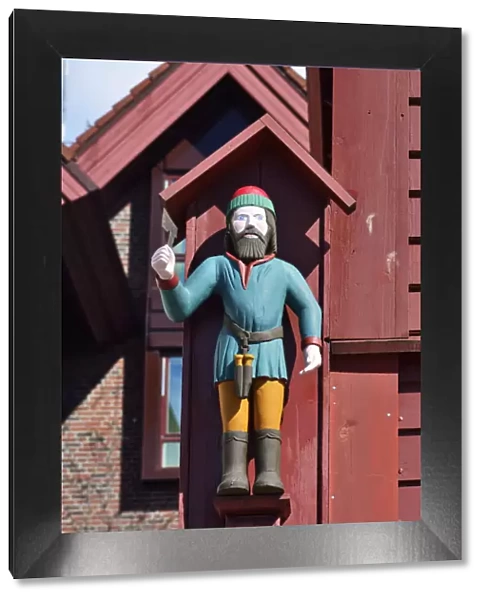 Wooden statue of St Jack on a wooden house facade. Warehouse in the Bryggen District