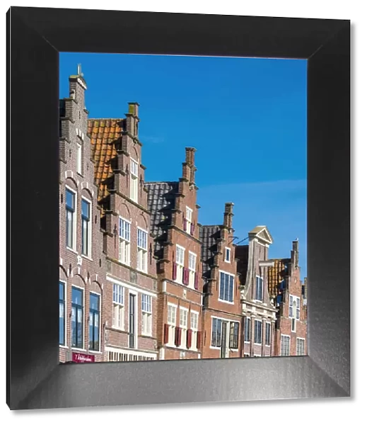 Netherlands, North Holland, Hoorn. Historic building facades along the Binnenhaven