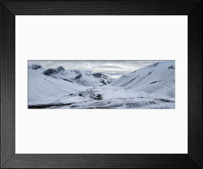Framed Print : Panoramic view of trail leading through snow covered valley to Rainbow Mountain
