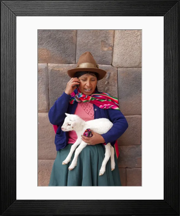 Framed Print : South America, Peru, Cusco. A Quechua woman standing in front of an Inca wall, holding Framed Print : South America, Peru, Cusco. A Quechua woman standing in front of an Inca wall, holding
