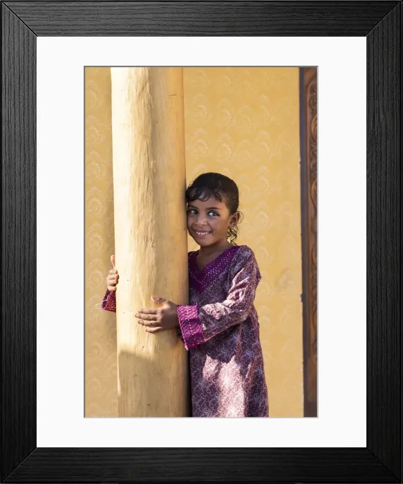 Framed Print : Middle East, Oman, Wahiba sands, a smiley bedouin girl wearing a pretty dress Framed Print : Middle East, Oman, Wahiba sands, a smiley bedouin girl wearing a pretty dress