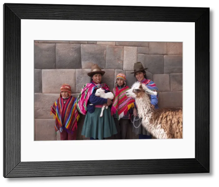 Framed Print : South America, Peru, Cusco. Quechua people standing in front of an Inca wall, holding