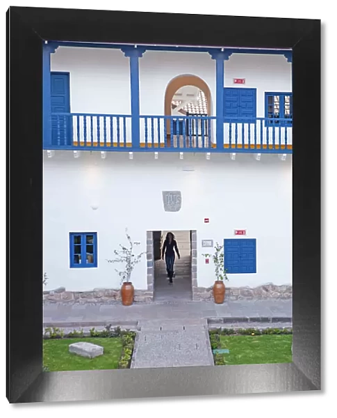 South America, Peru, Cusco, a model walks through an interior courtyard in the