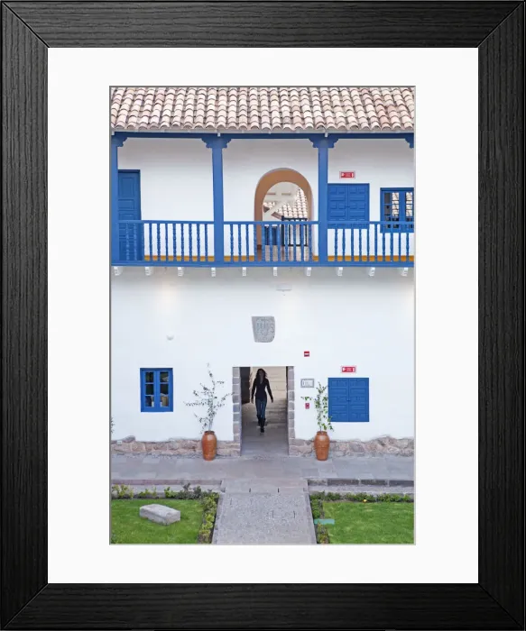 Framed Print : South America, Peru, Cusco, a model walks through an interior courtyard in Framed Print : South America, Peru, Cusco, a model walks through an interior courtyard in