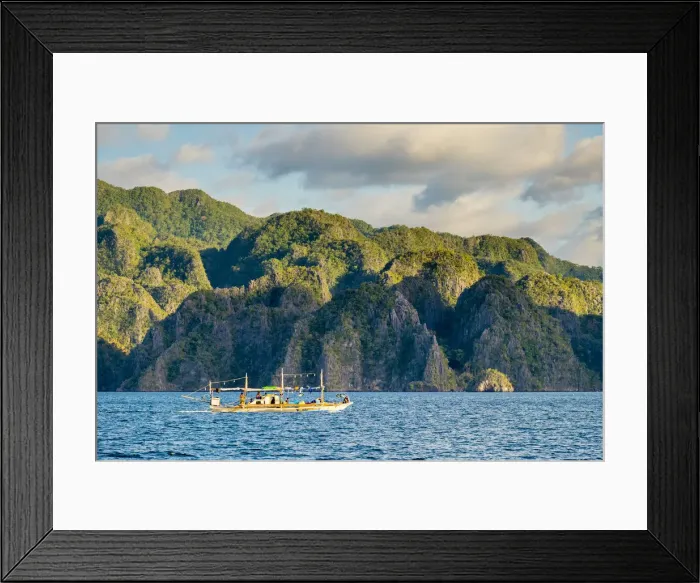 Framed Print : Filipino outrigger fishing boat and dramatic karst landscape of Coron Island, Palawan Framed Print : Filipino outrigger fishing boat and dramatic karst landscape of Coron Island, Palawan