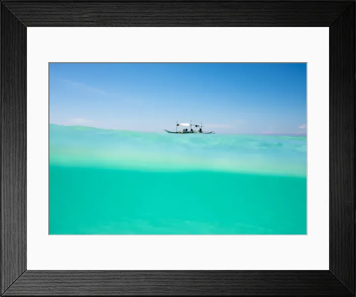 Framed Print : Over-under shot of Philippine outrigger boat in turquoise ocean water off the coast Framed Print : Over-under shot of Philippine outrigger boat in turquoise ocean water off the coast