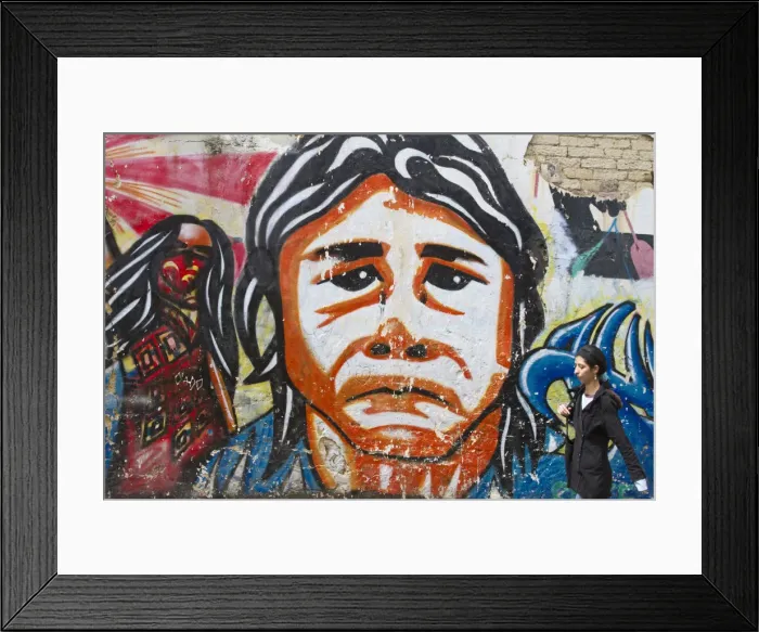 Framed Print : Colombia, Bogota, La Candelaria, Woman walking past Graffiti on building Framed Print : Colombia, Bogota, La Candelaria, Woman walking past Graffiti on building