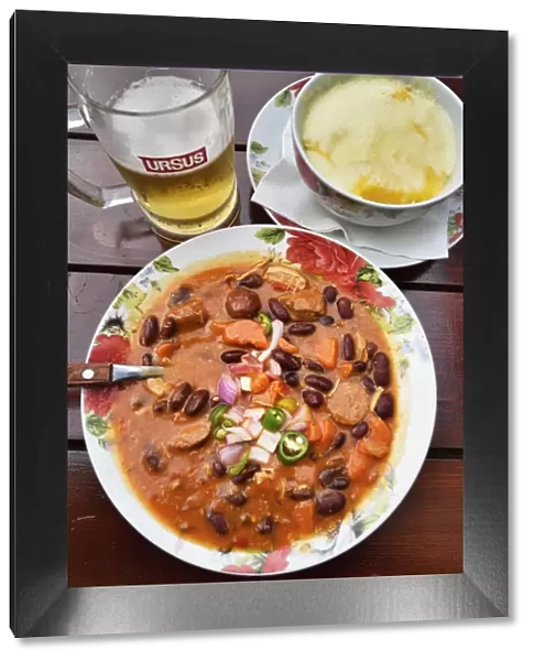 Traditional pork goulash prepared with hot sausages and red beans and traditional