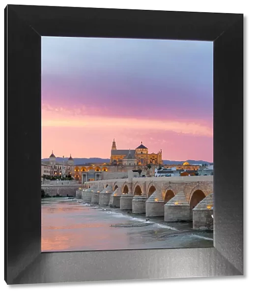 Cathedral (Mezquita) and Roman bridge at sunset, Guadalquivir river, Cordoba, Andalusia
