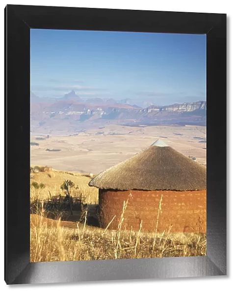 Village hut with Cathedral Peak in background, Ukhahlamba-Drakensberg Park, KwaZulu-Natal