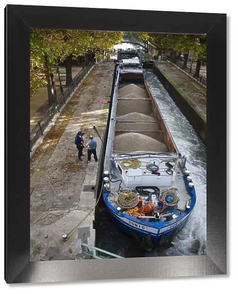 France, Paris, Canal St-Martin, barge in canal locks by the Quai de Jemmapes