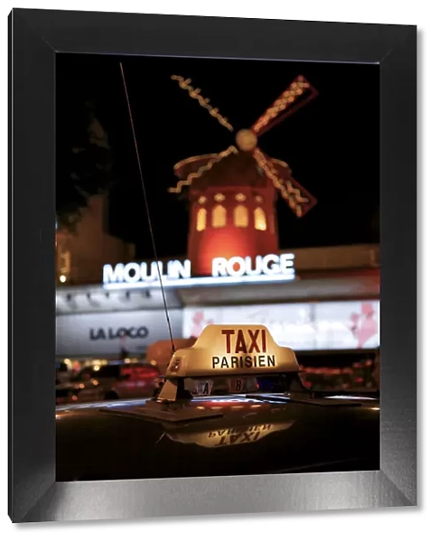 Taxi sign with Moulin Rouge in background, Paris, France