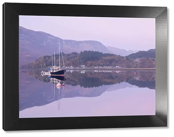 Yachts moored on a mirror still Loch Leven during twilight, Glencoe, Highland, Scotland