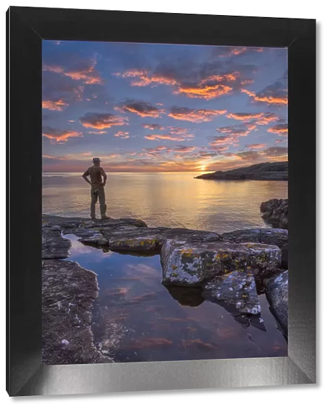 Europe, United Kingdom, Scotland, man on coast near Lochinver at sunset (MR) (m)