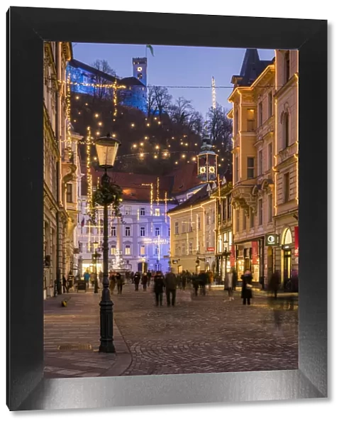Sritar street with Ljubljana Castle in the background adorned with Christmas lights