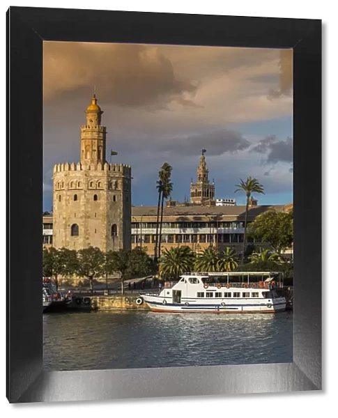 Torre del Oro watchtower with Giralda bell tower in the background, Seville, Andalusia