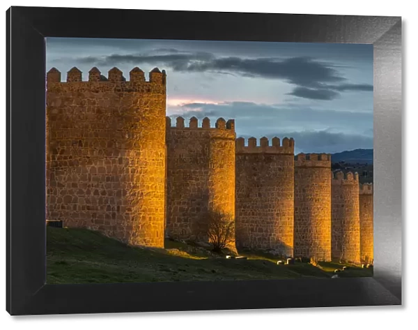 The medieval city walls illuminated at dusk, Avila, Castile and Leaon, Spain