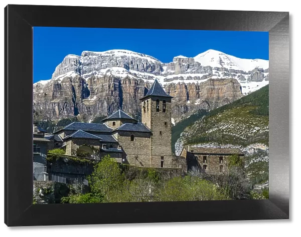 The mountain village of Torla with the snowy Pyrenees behind, Huesca, Aragon, Spain