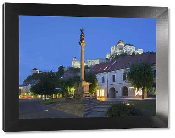 Monument in Mierove Square and Trencin Castle at dusk, Trencin, Trencin Region, Slovakia